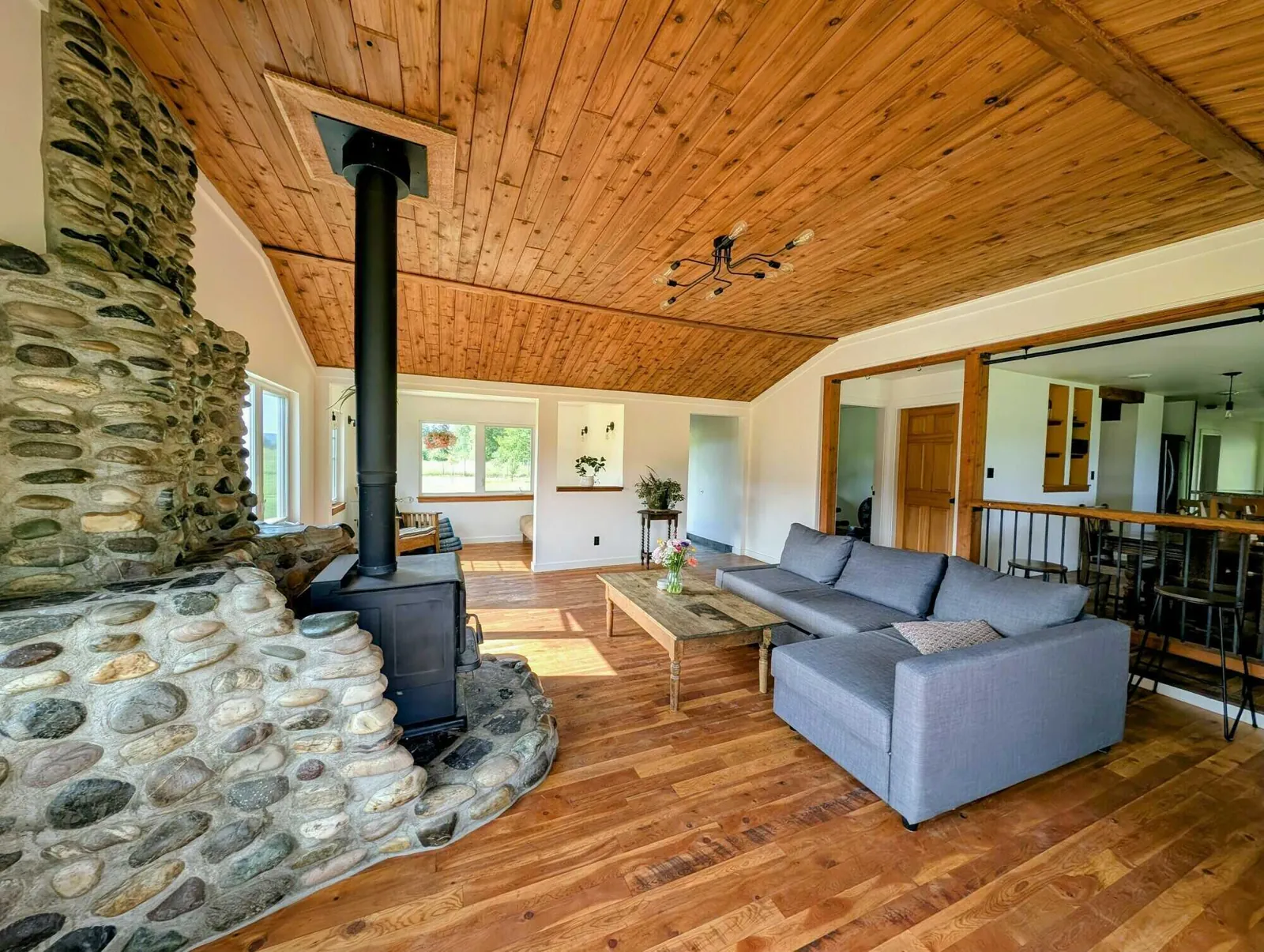 The living room, with its Pacific Energy wood stove set in rockwork