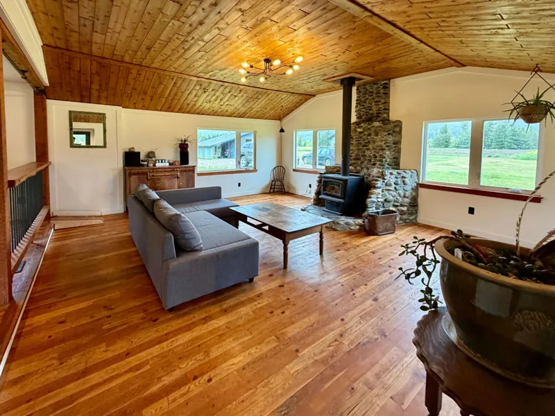 The wood ceiling and wide windows in the living room