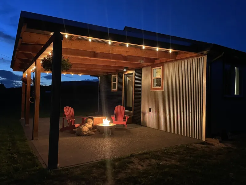 The big covered porch by firelight