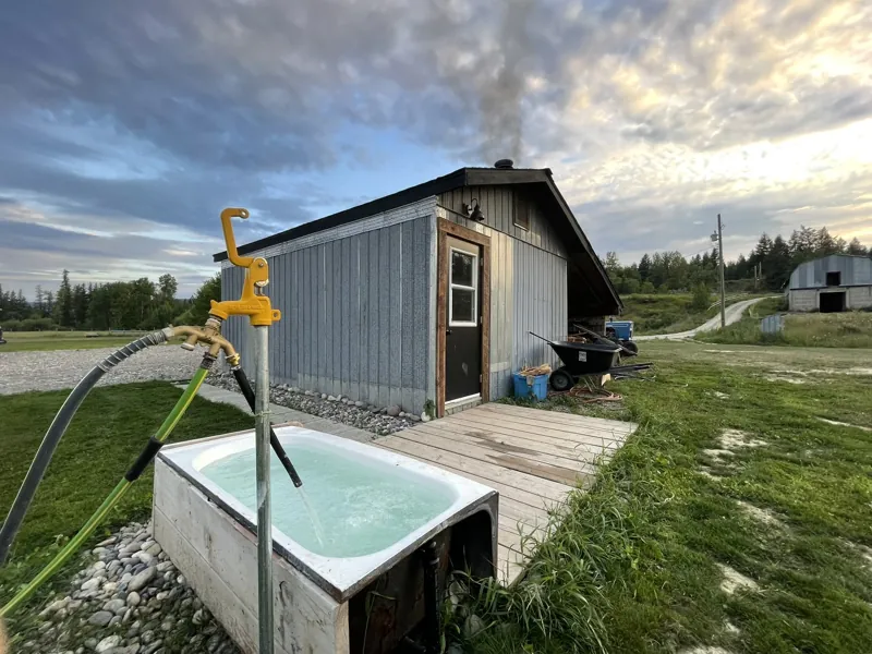The sauna building, with the outdoor tub beside it