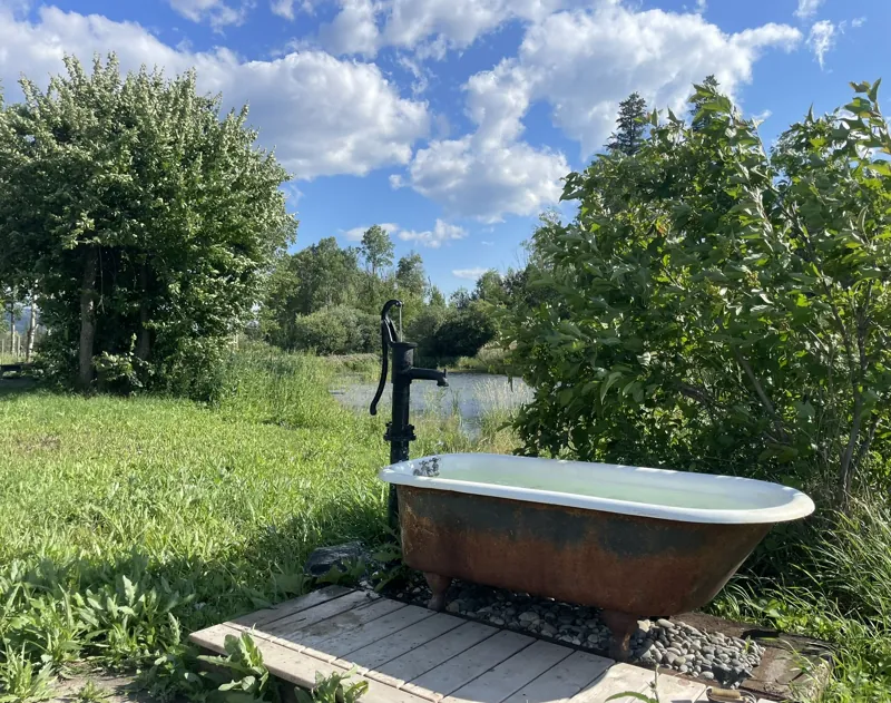 The cast-iron tub water feature beside the pond
